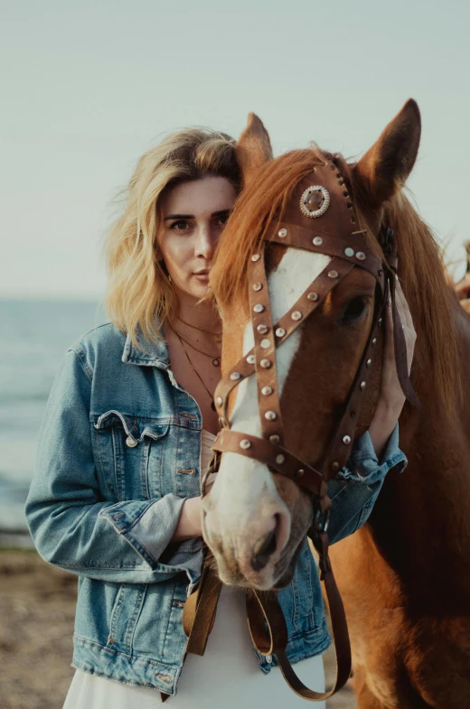 the young lady is holding her horse close to her face