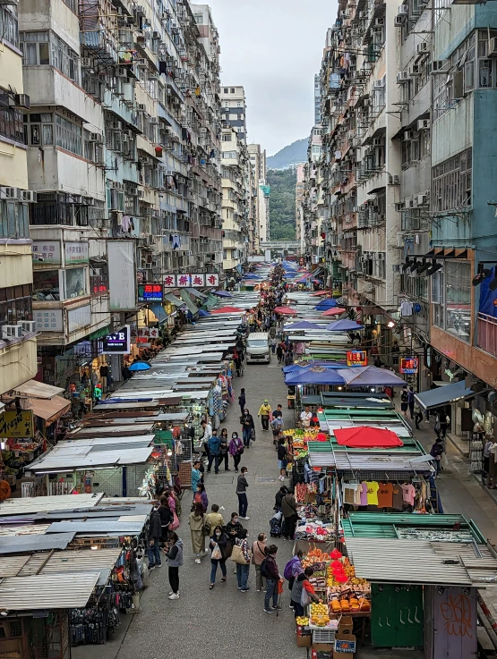 a view from above of an open market, with people walking around