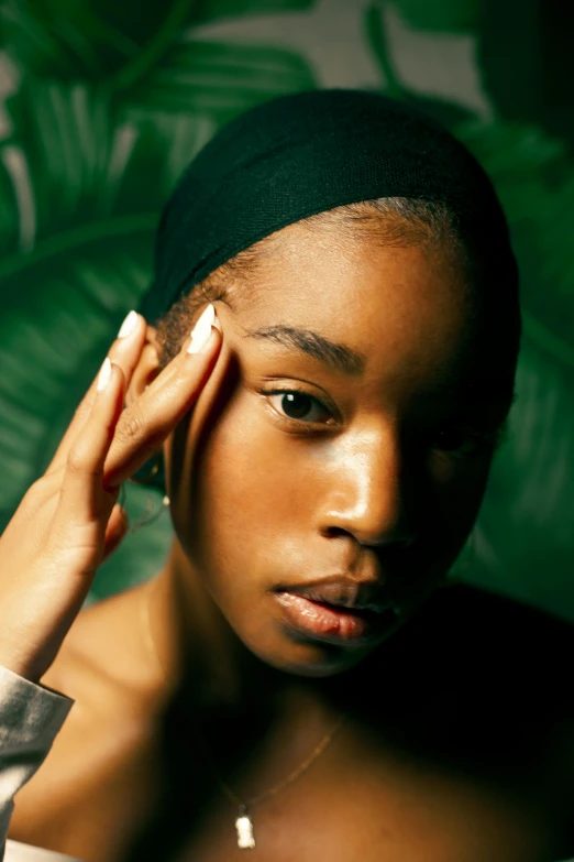 a black female is wearing a beanie and a headband