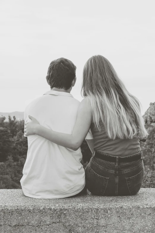 a black and white po of a man and woman overlooking trees