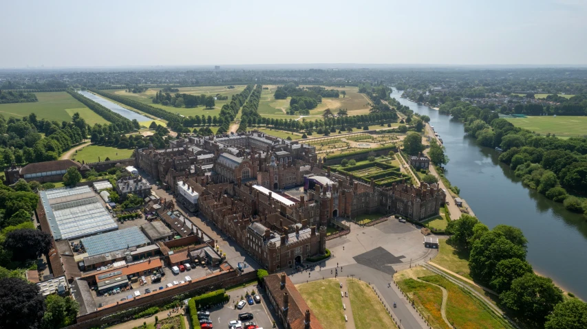 an aerial view of an old building next to a river