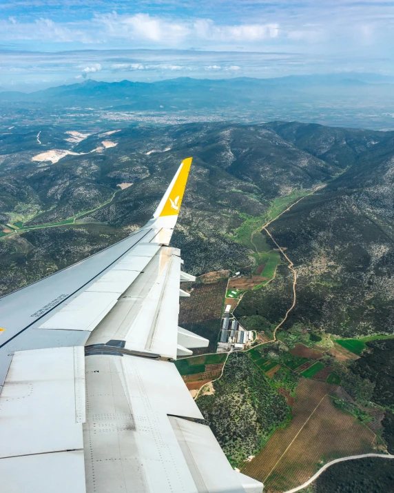 view from an airplane looking over a green landscape