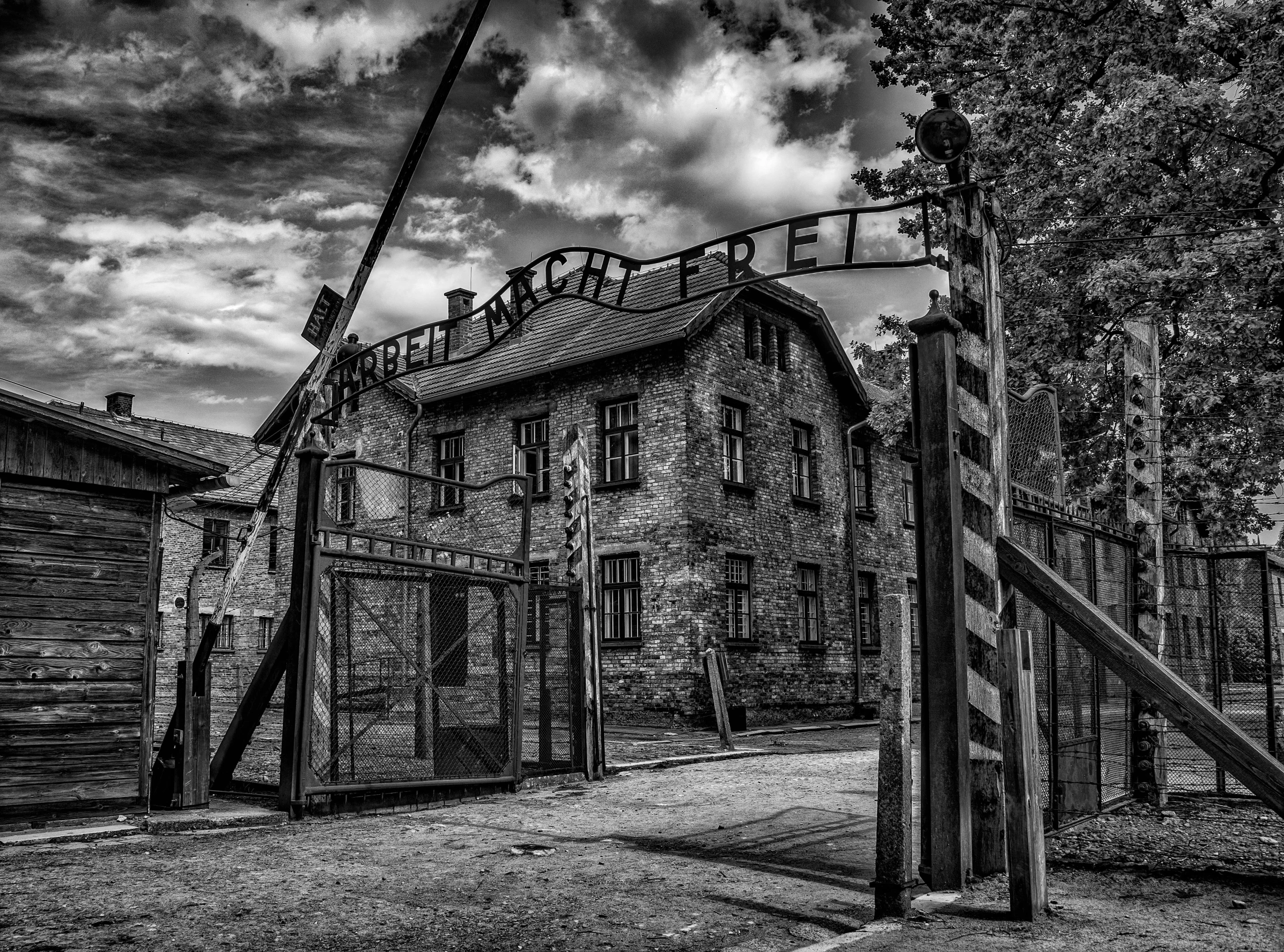 an old run down brick building that has a fence in front of it