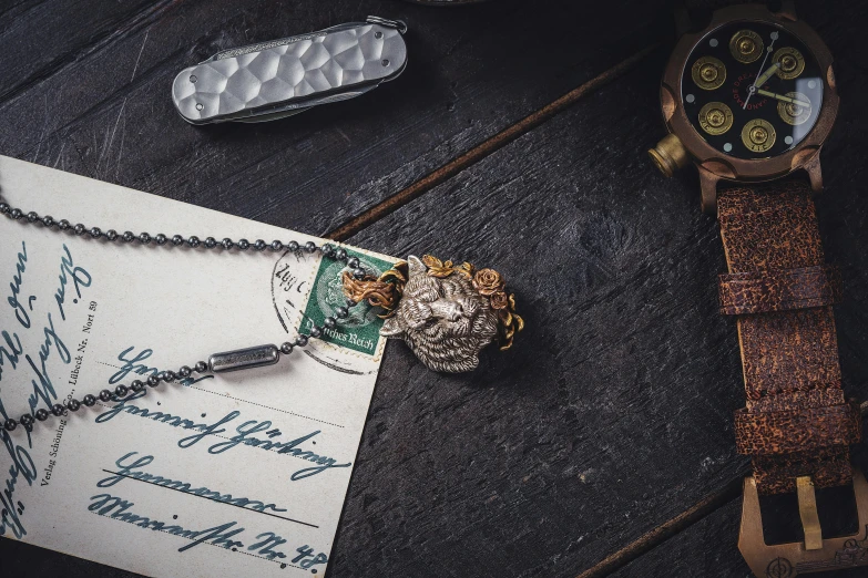 an old letter sits in front of a watch