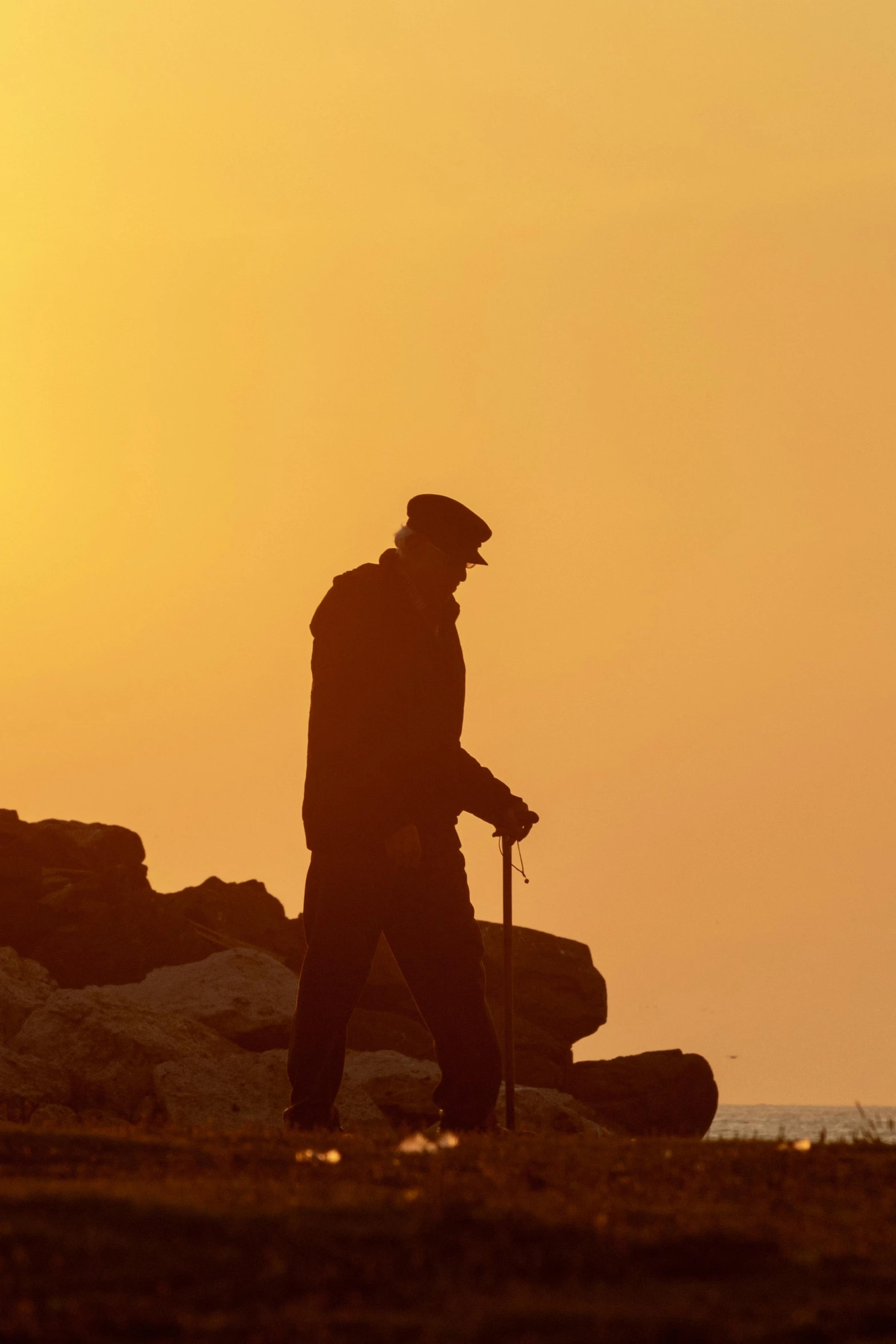 a person standing on top of a field near the sun