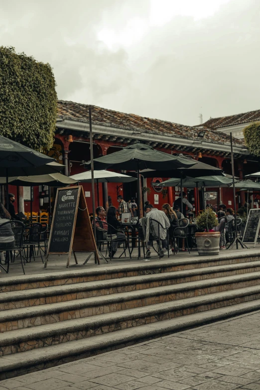 a group of people sitting at outdoor tables