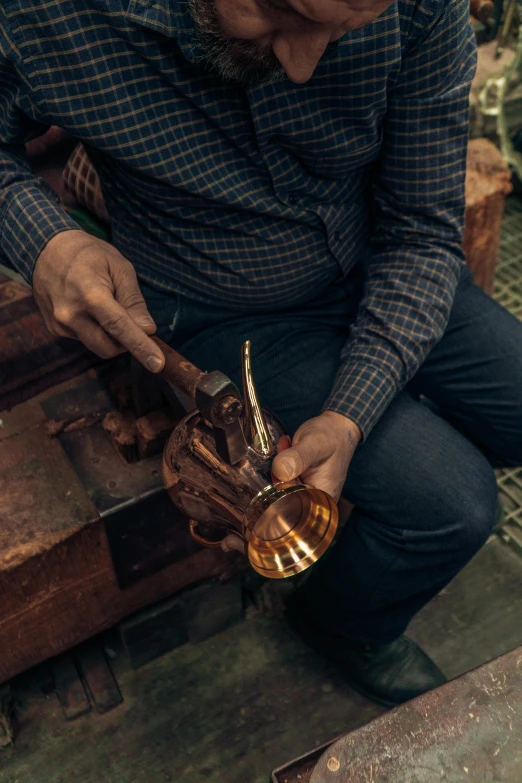 a man is holding a ss cup and some scissors