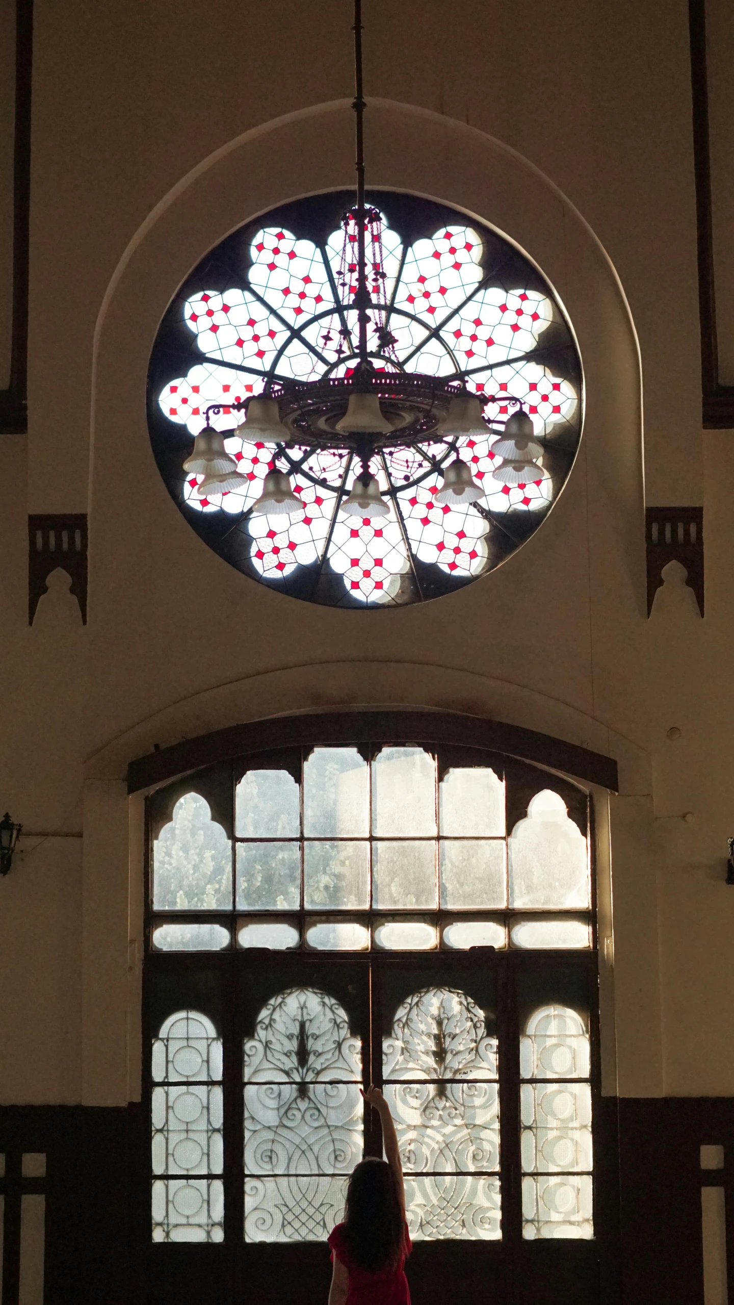 a girl points towards stained glass in a cathedral