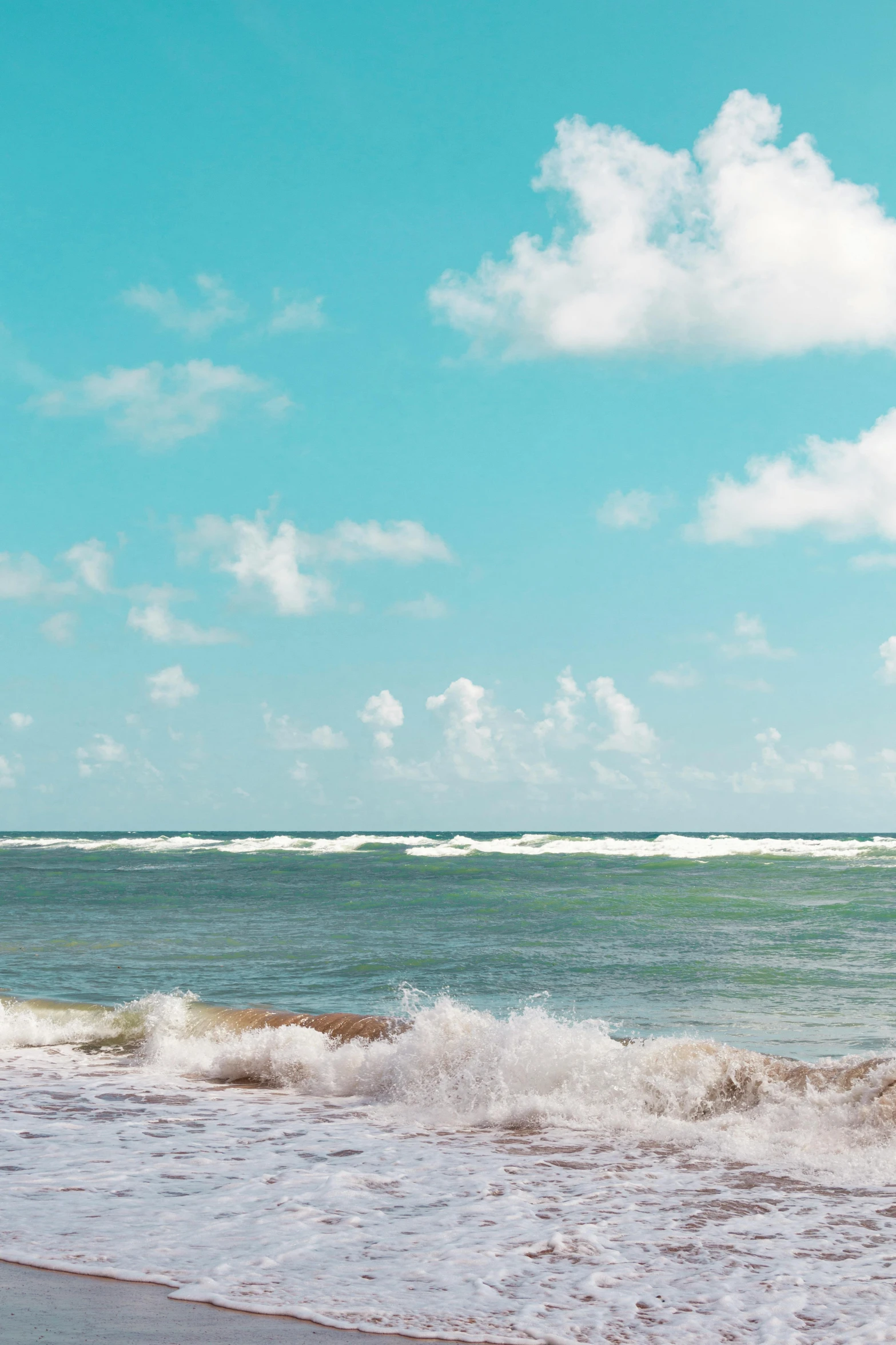 a woman is standing in the water with her surfboard