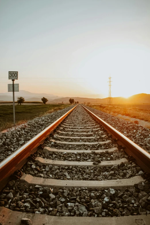 a long train track going into the sunset