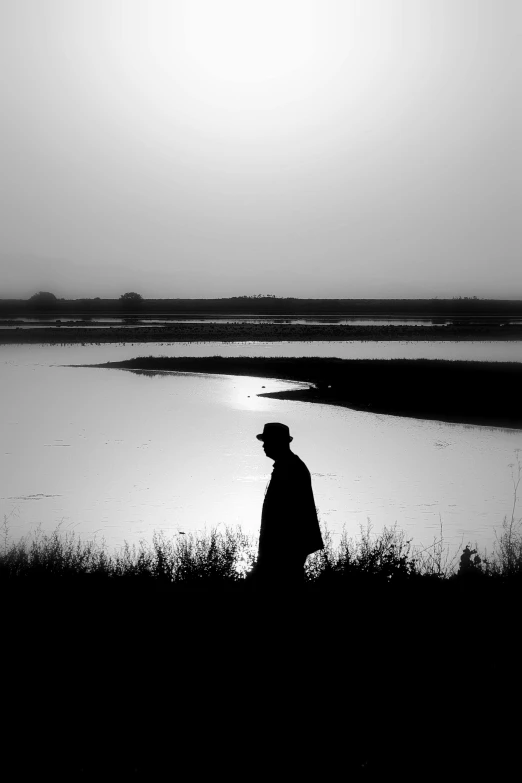 black and white pograph of man on an open field