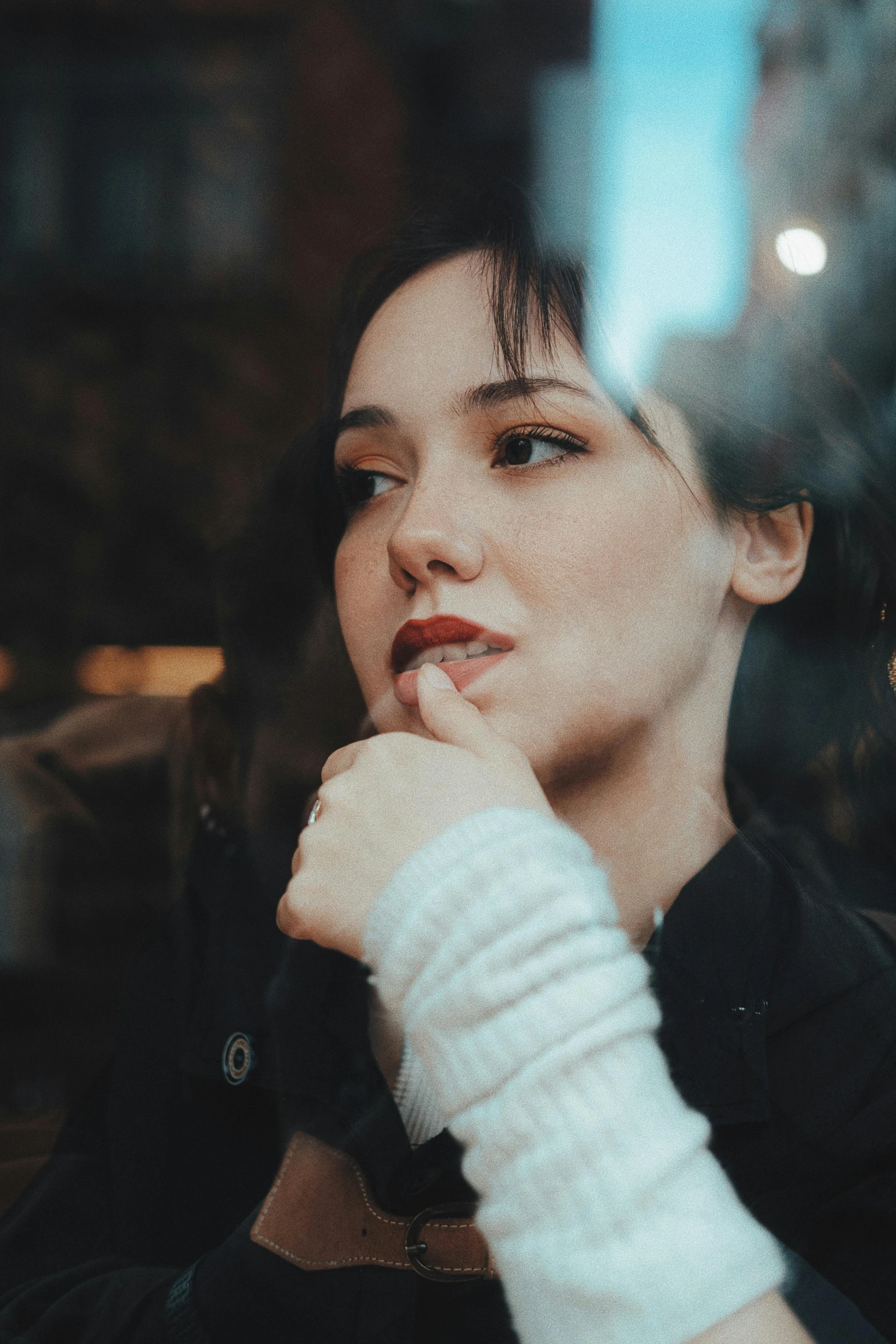 the woman is smoking in front of the window