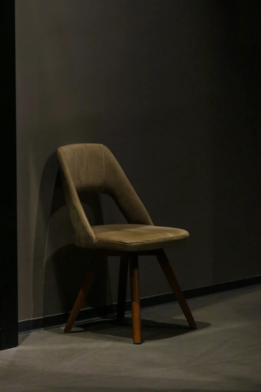 an empty chair against a wall