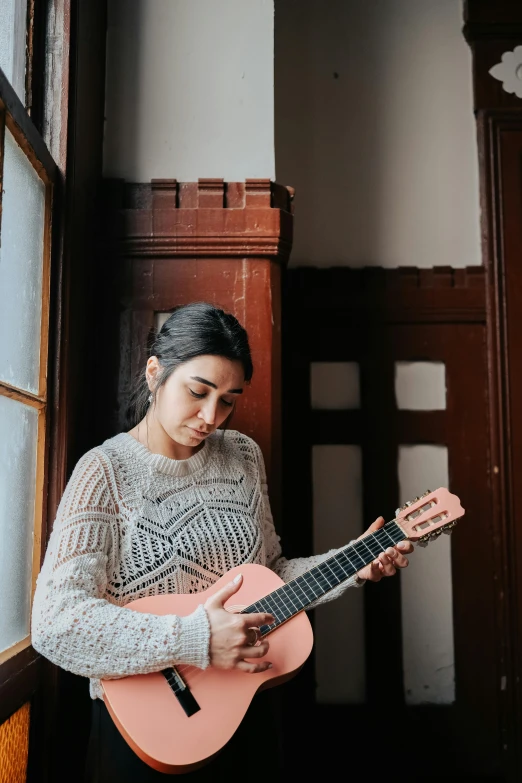 a woman wearing a black and white outfit holding a guitar