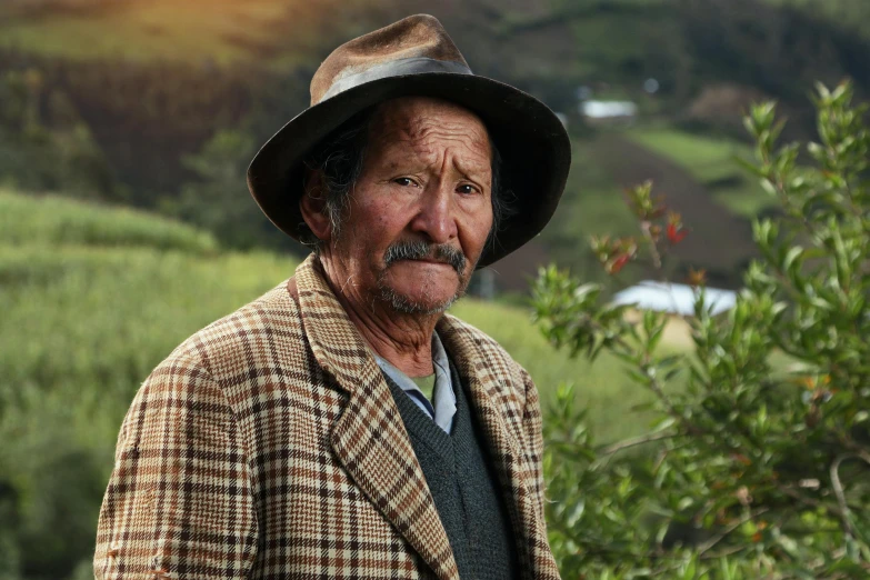 old man with long beard wearing a coat and hat