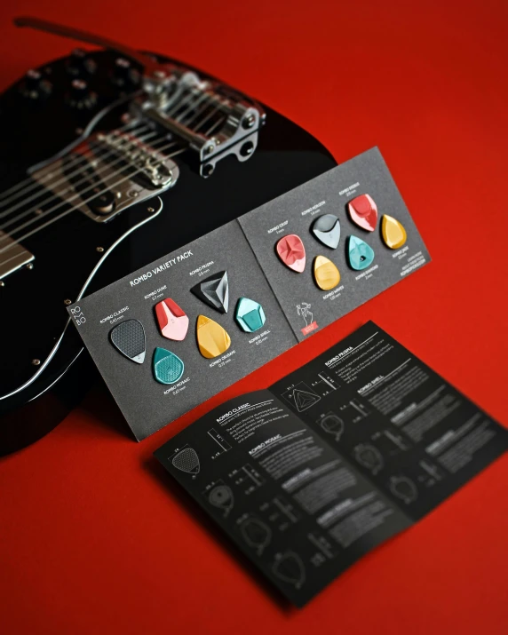 a business card with several guitar picks attached to it