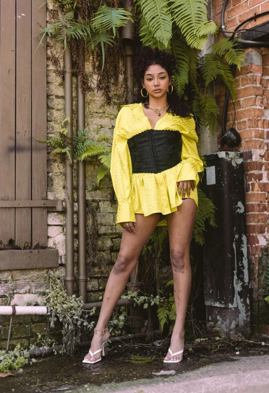 woman in yellow dress with black underbusk and boots