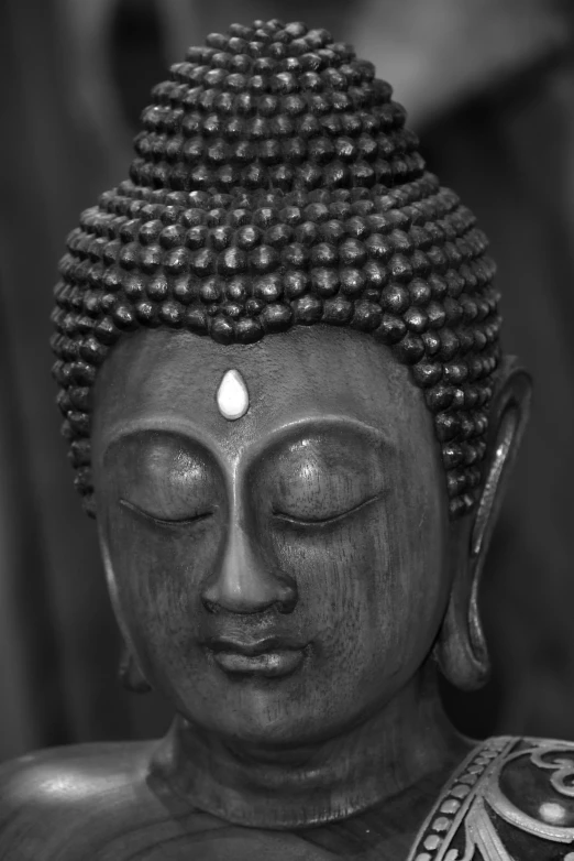 a buddha head is covered in beads and pearls