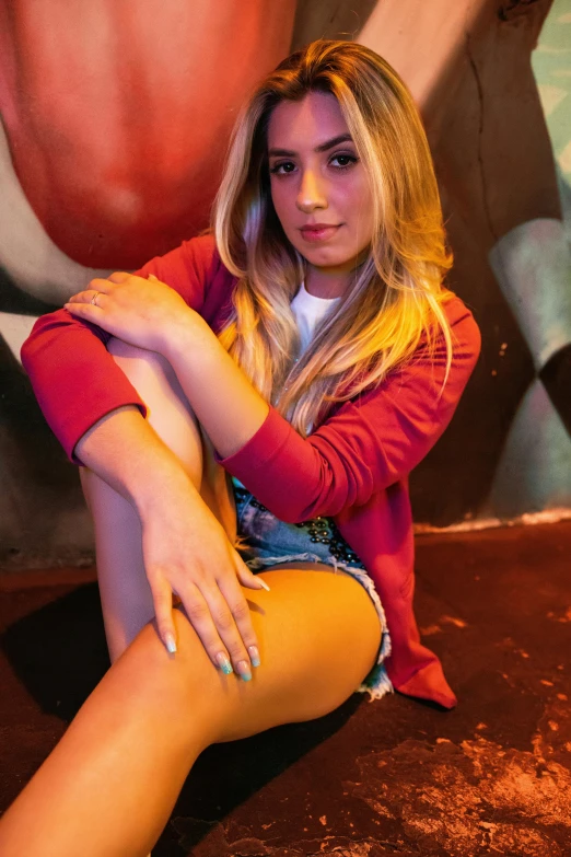 a blonde woman is posing on a red carpet