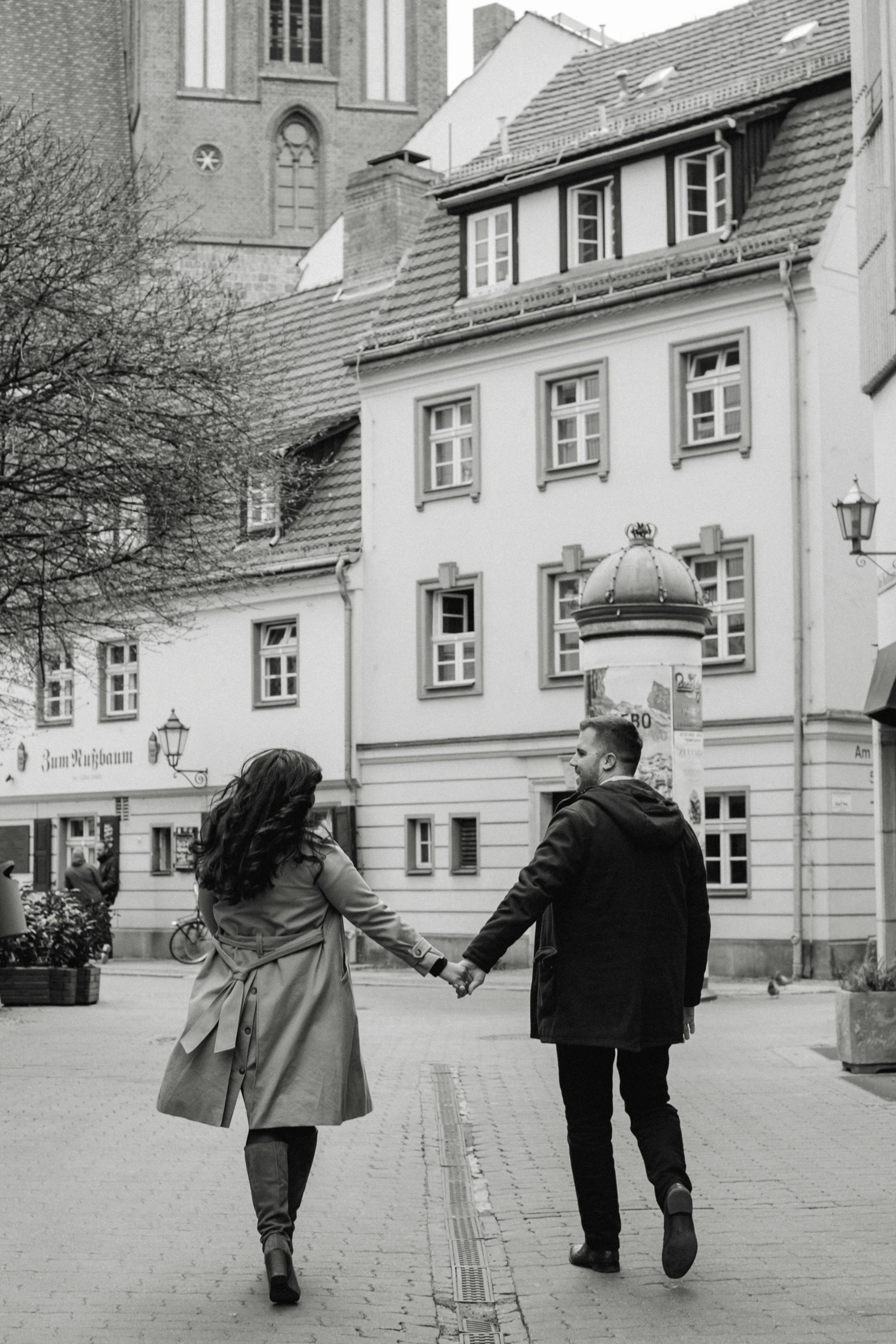 couple in love walking together on an alley, holding hands