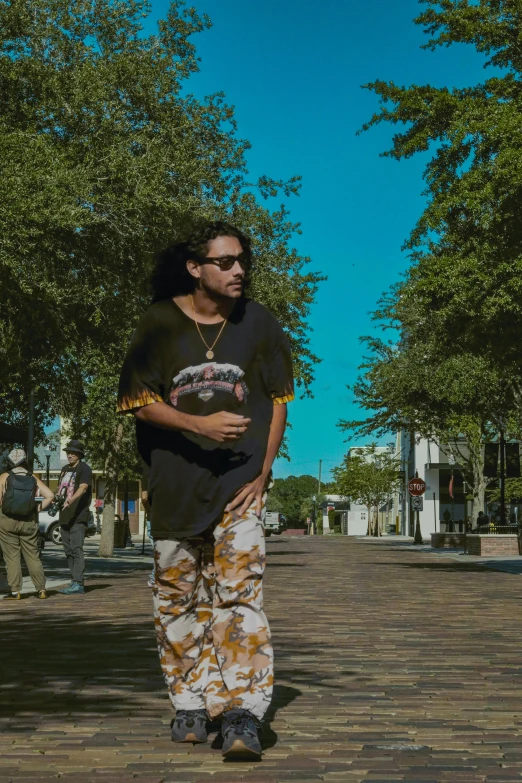 a person with sunglasses standing in a brick road