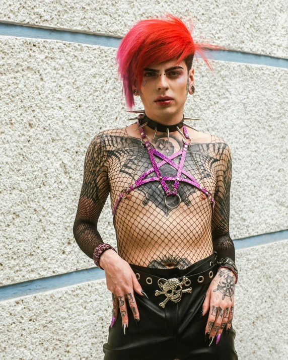 a lady with tattoos, piercings and piercing nails