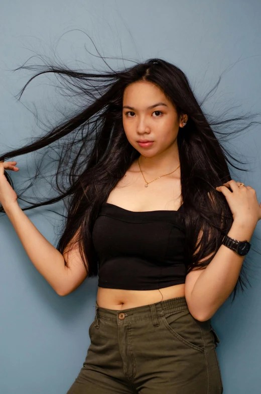 the young asian girl poses with her long hair