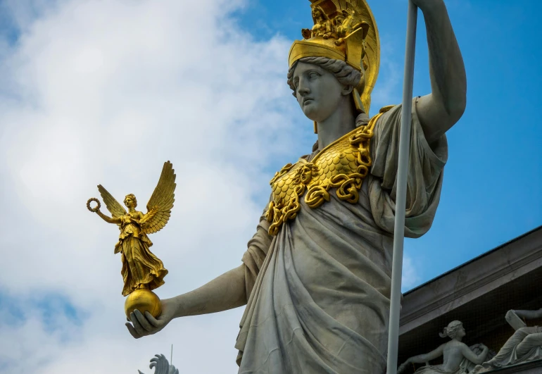 the statue of the goddess holding the scales is holding the bird