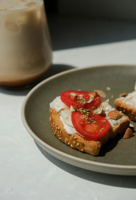 a piece of bread with tomatoes and whip cream on it