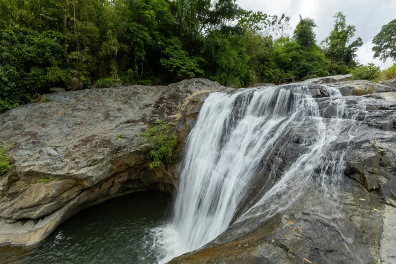 the waterfall at the bottom of the mountain has a narrow opening