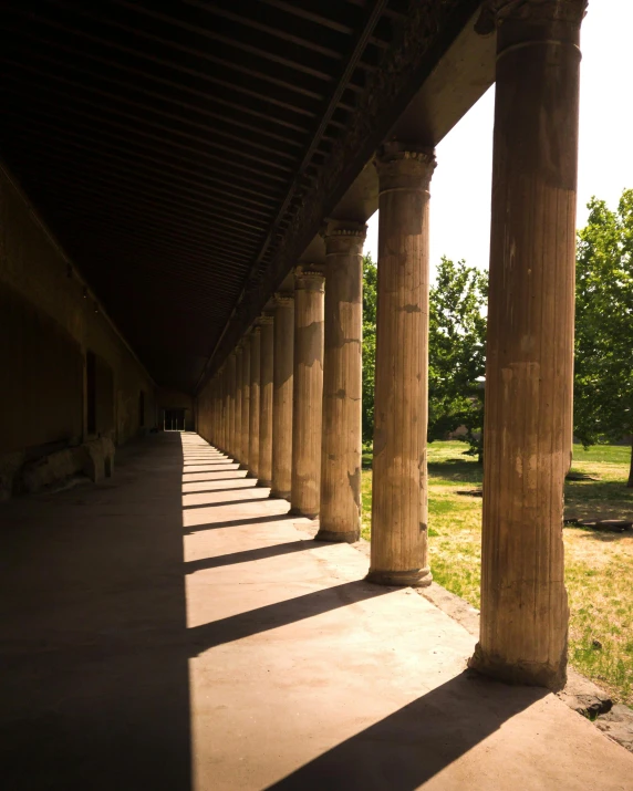 long row of columns line the side of a building