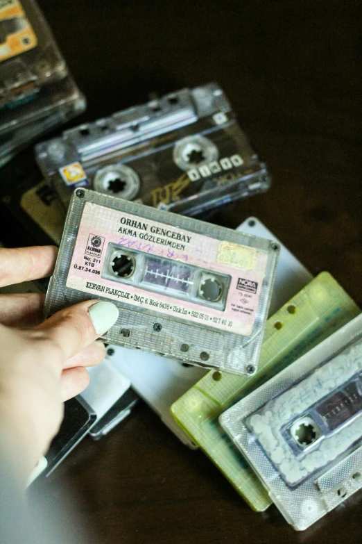 a person putting a cassette in their hand