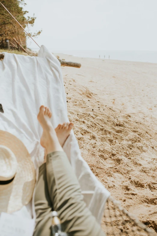 a person laying on a beach covered with white sheets