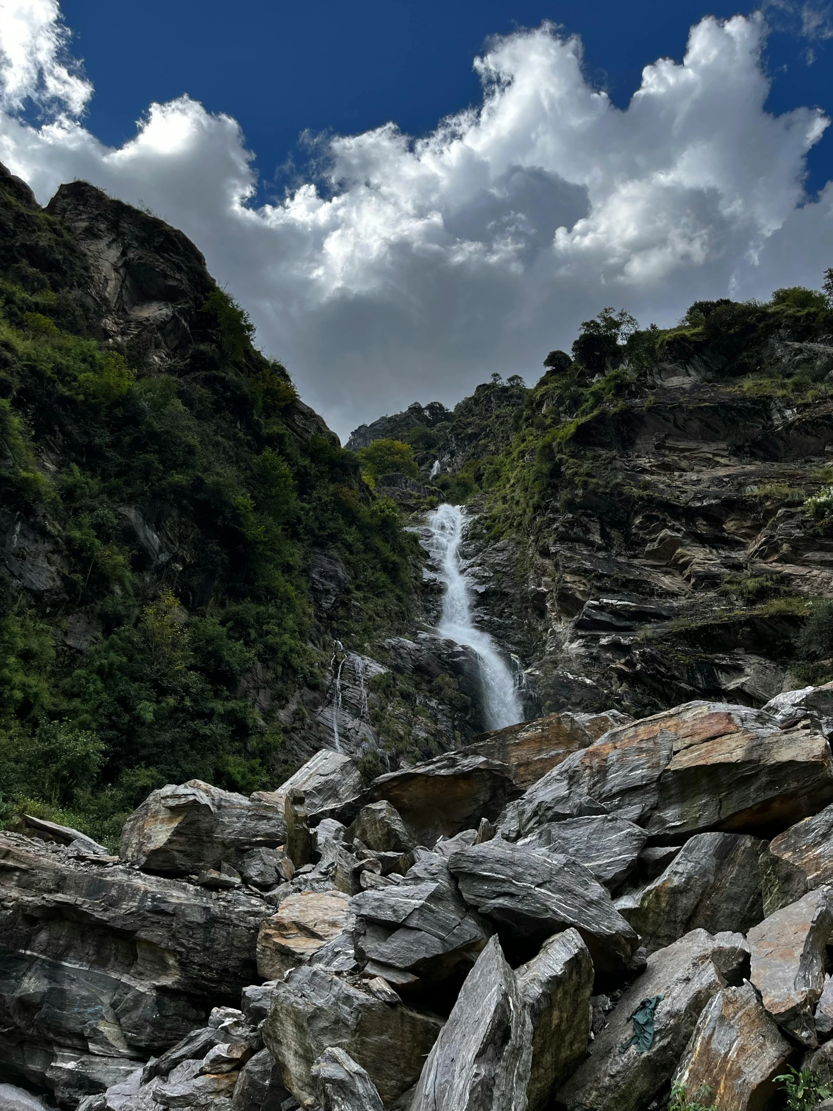 a beautiful waterfall on a mountain with large rocks