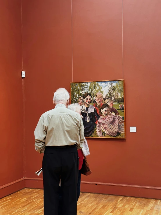 a woman standing in front of an oil painting