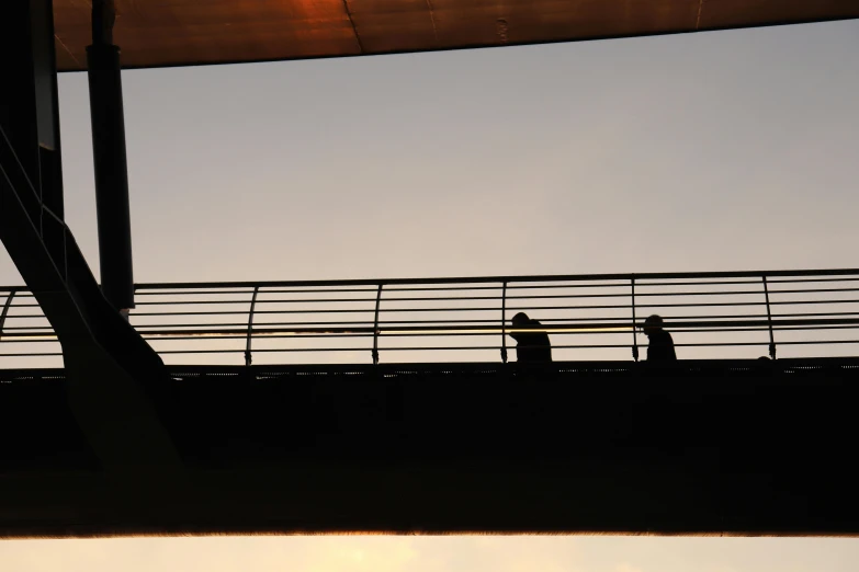 some people that are standing on a bridge