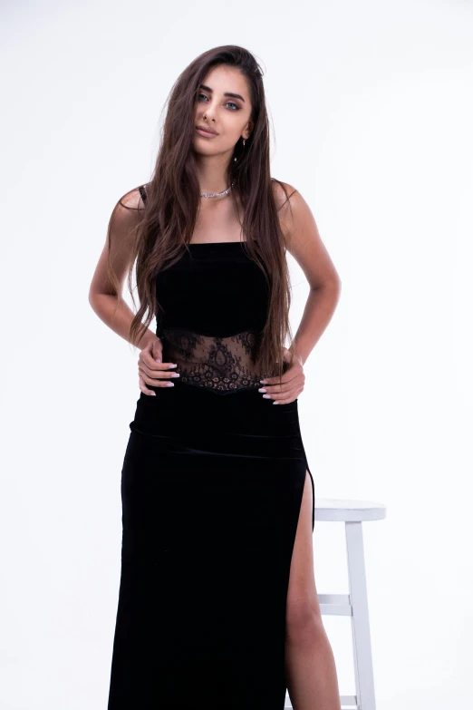 the woman is posing in her black dress