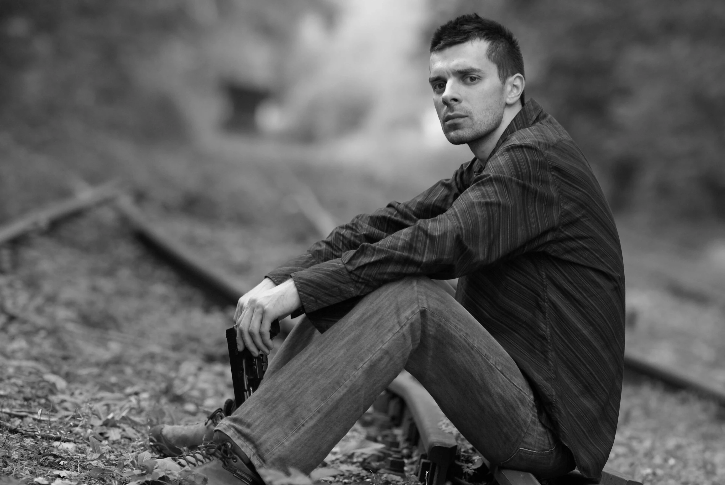 a man sitting in the road while holding a camera