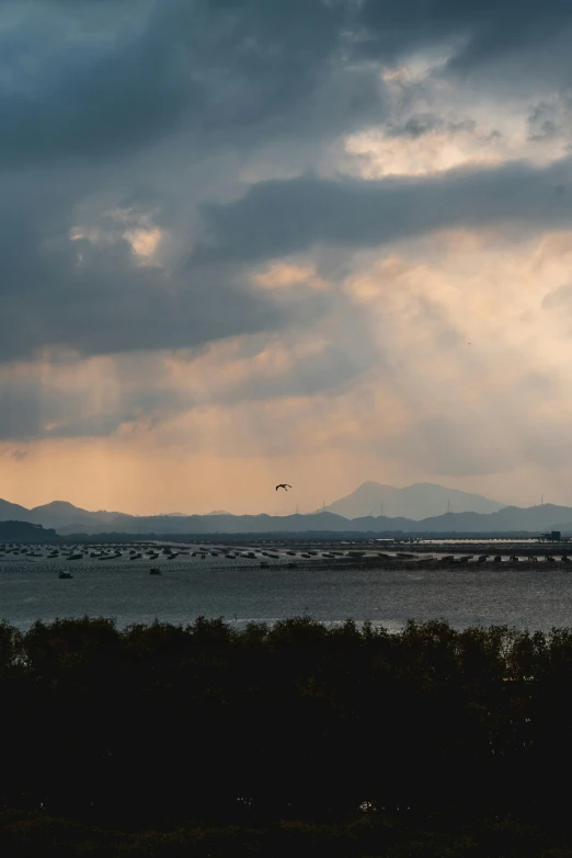 clouds moving in and out with a boat out front