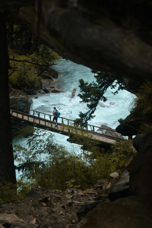 people standing on a bridge over the water