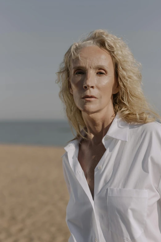 woman in a white shirt on a sandy beach