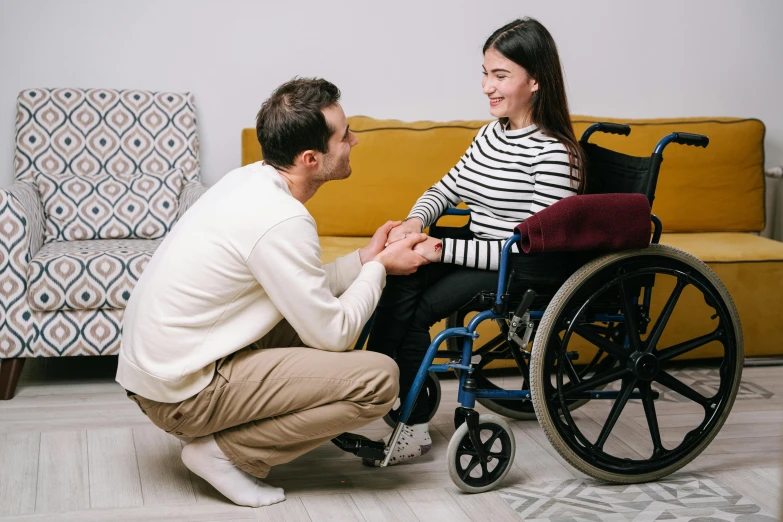 a man is looking at his wife in a wheelchair