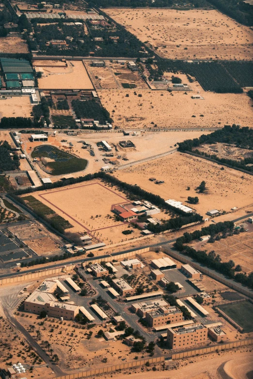 an aerial view of houses and cars in a large construction area