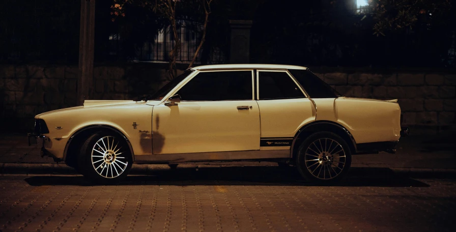 a car parked on a dark street in the night