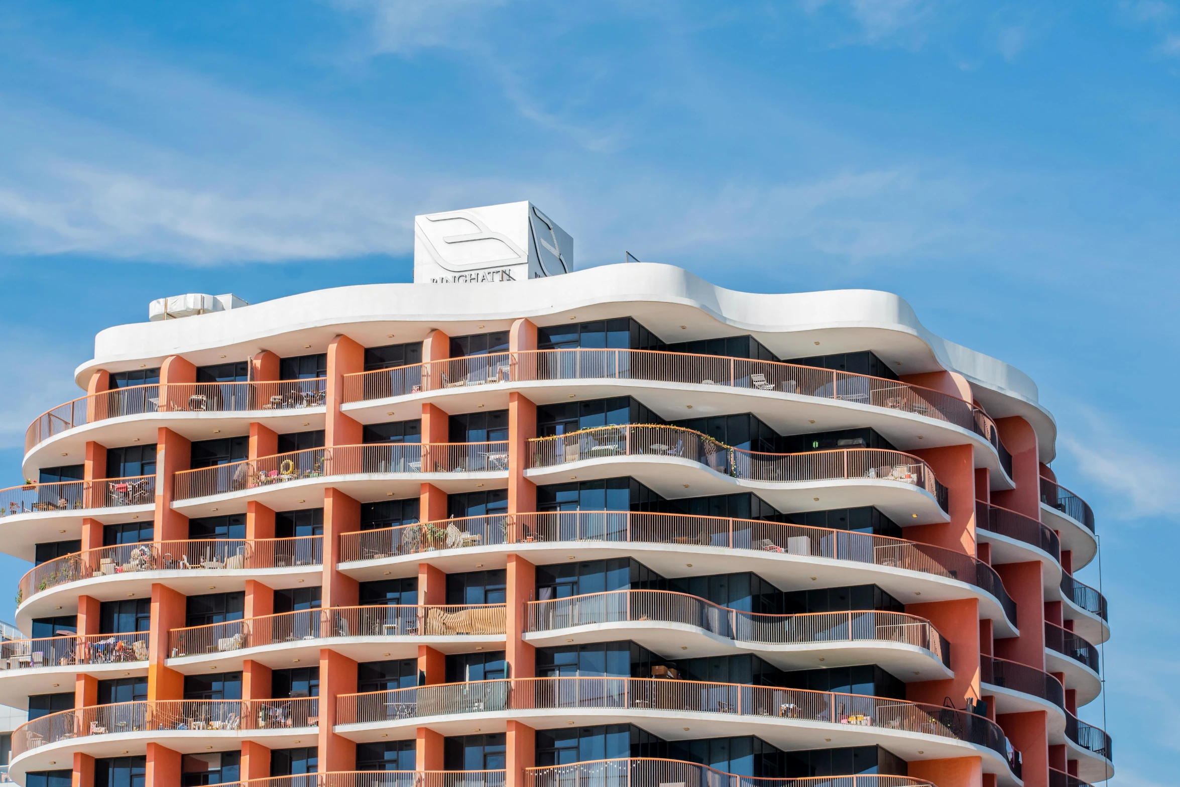 an orange and white building is against the blue sky