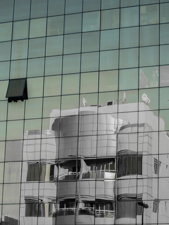 a reflection of a building in glass