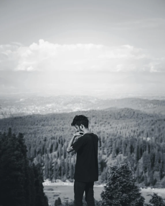 a man standing on top of a mountain looking at the sky