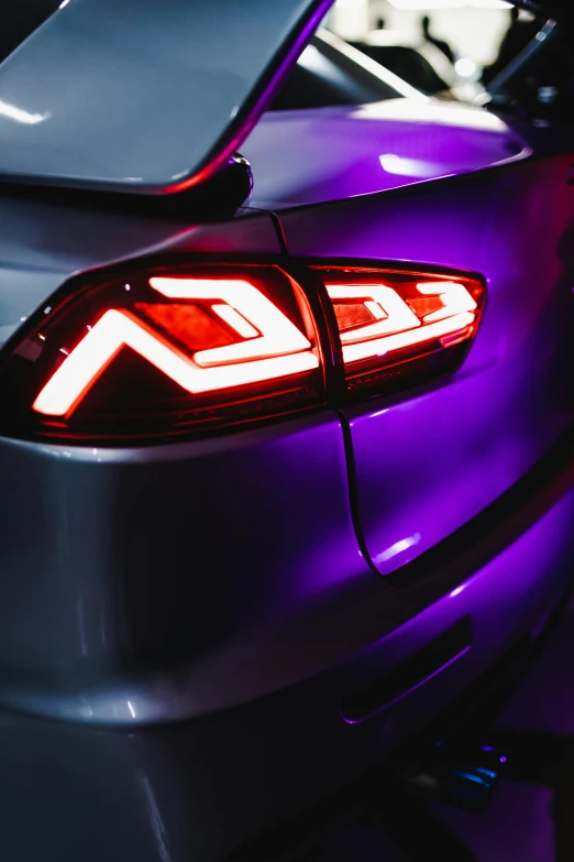 a car with a purple tail light in the trunk