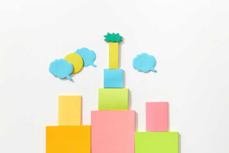 a group of different colored paper blocks with some shapes