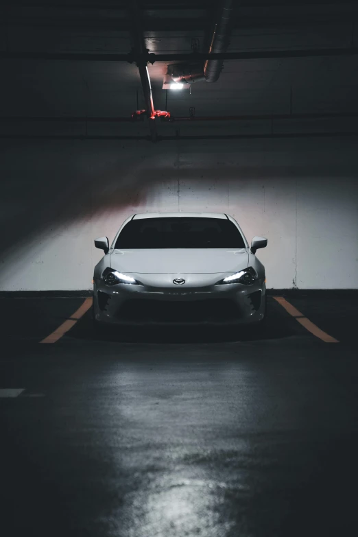 the front view of a white and black vehicle in a parking lot